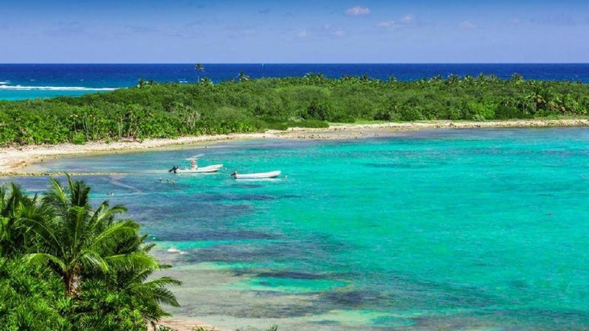 Aerial view of Punta Allen bay in Sian Kaan Biosphere Reserve with turquoise lagoon and lush jungle