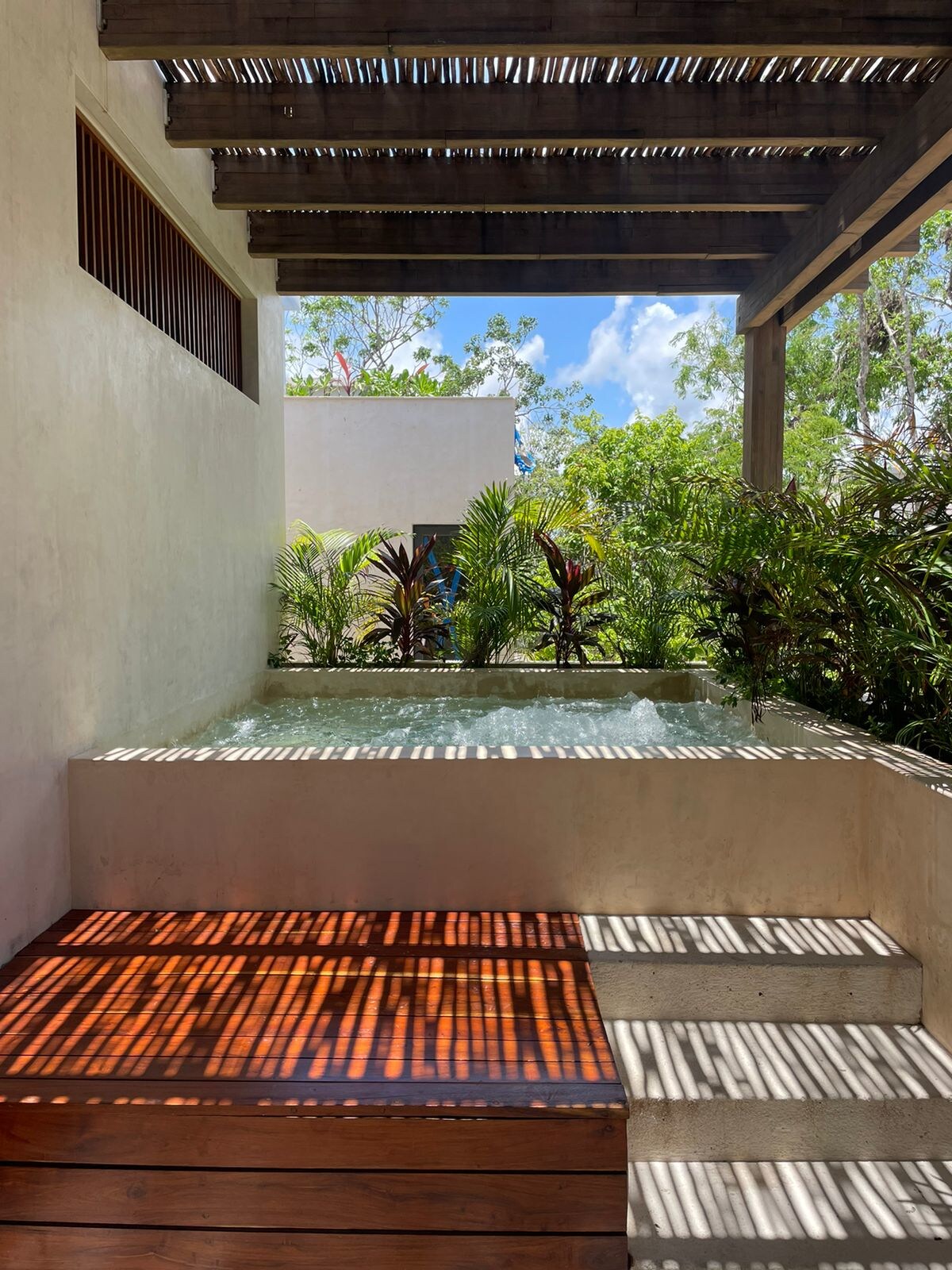 Villa entrance with lush jungle landscaping