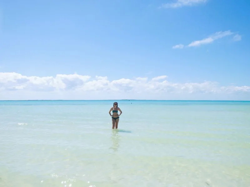 Aimee standing in the shallow turquoise sea at Holbox